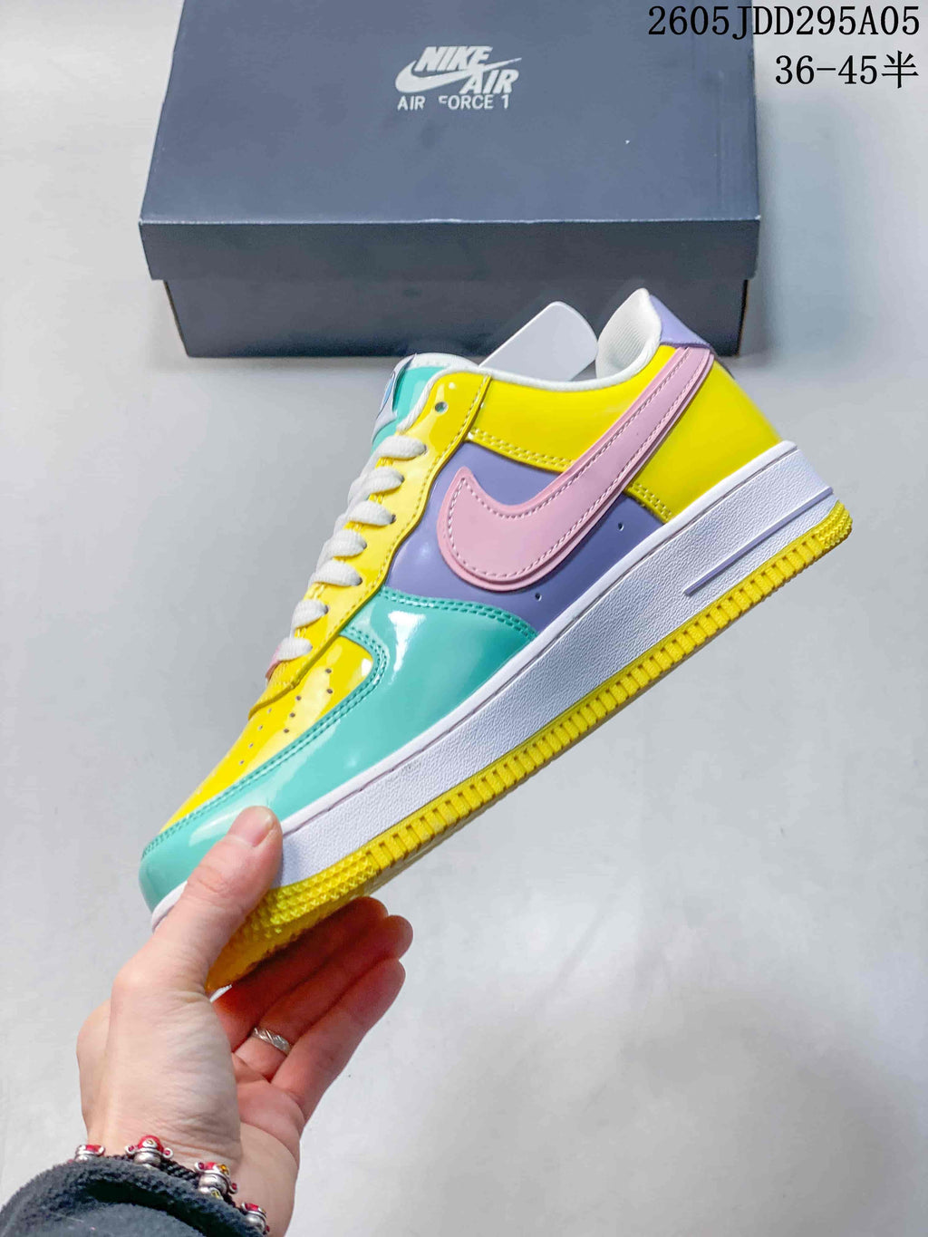 Side profile of the low-top sneaker showing the pink Swoosh, lavender side panel, yellow upper, turquoise toe area, white midsole and yellow outsole.