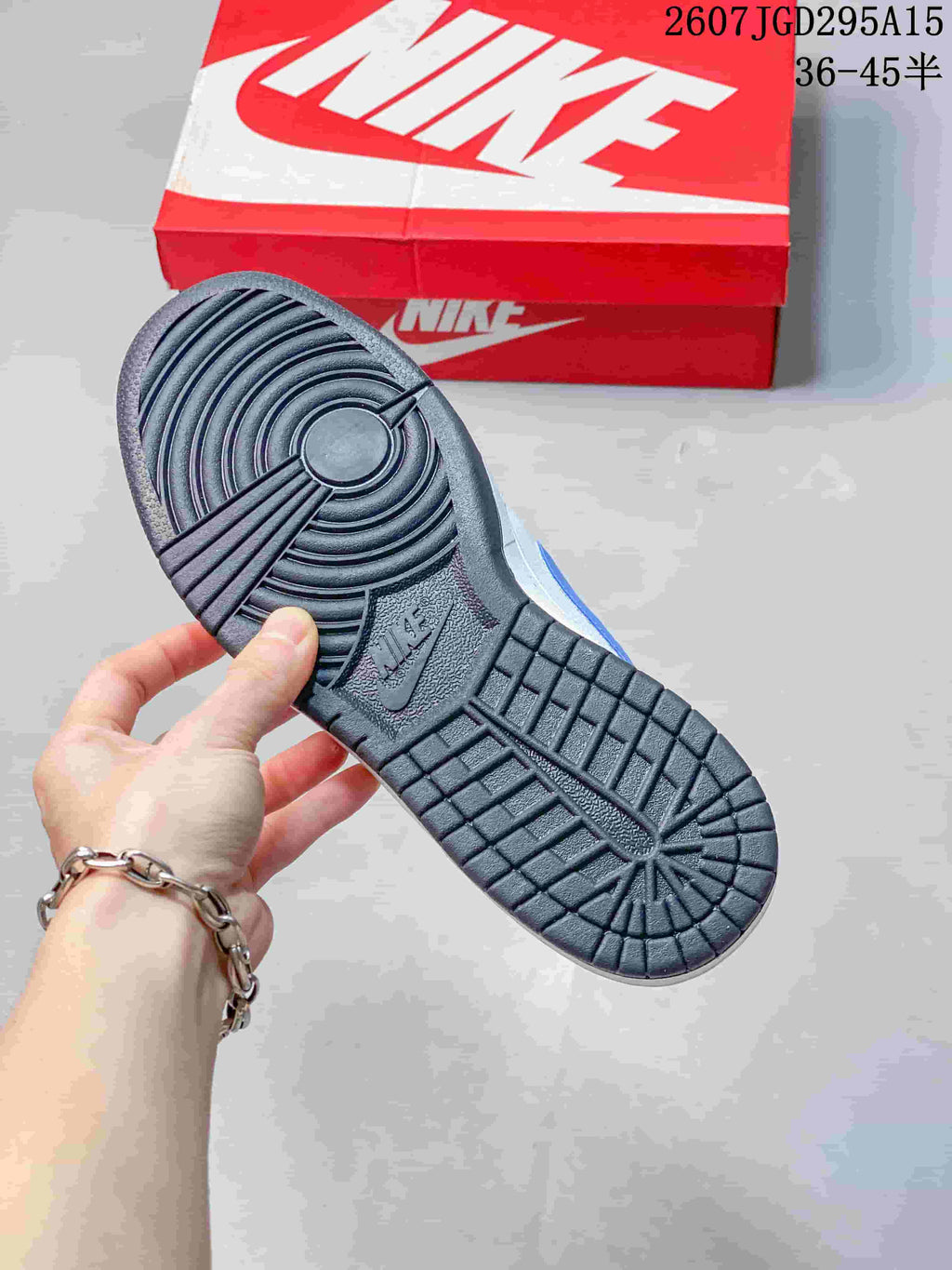 Underside view showing the black rubber outsole with circular forefoot and heel traction patterns.