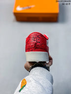 Rear view showing the red textured heel overlay and white rubber midsole.