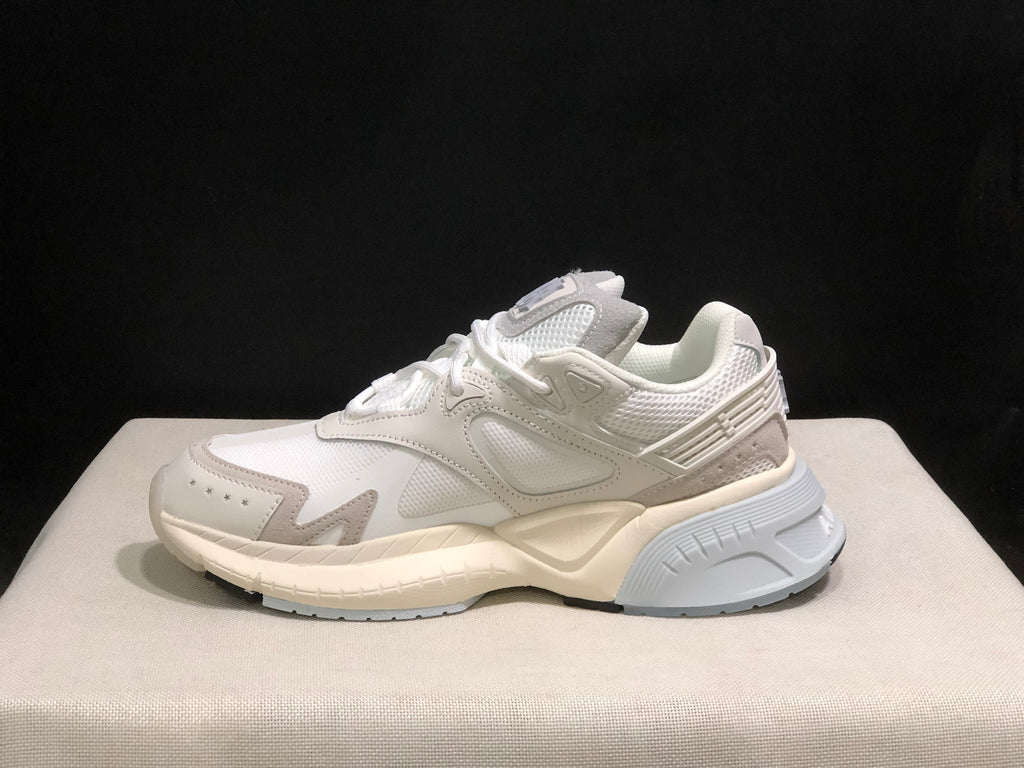 Side profile showing the mesh-style sections, layered panels and sculpted outsole.