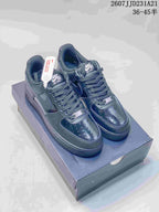 Pair of black Nike Air Force 1 low-top sneakers displayed on a shoe box.