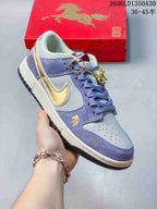 Angled side view of the lavender and light gray Nike SB Dunk Low with gold accents and horse-themed graphics.