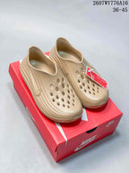 Pair of tan Nike ReactX Rejuven8 clogs displayed on a red Nike shoe box; style code 2607WY776A16 and size range 36–45 are visible.