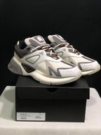 Front three-quarter view of the pair displayed on a black AMIRI shoe box.