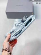 Side view of the light gray clog sandal highlighting the platform sole, side cutouts, and heel strap attachment.