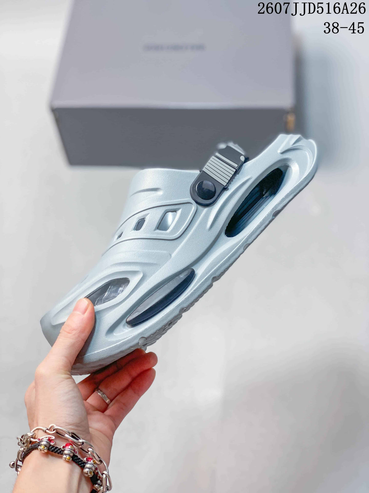 Side view of the light gray clog sandal highlighting the platform sole, side cutouts, and heel strap attachment.