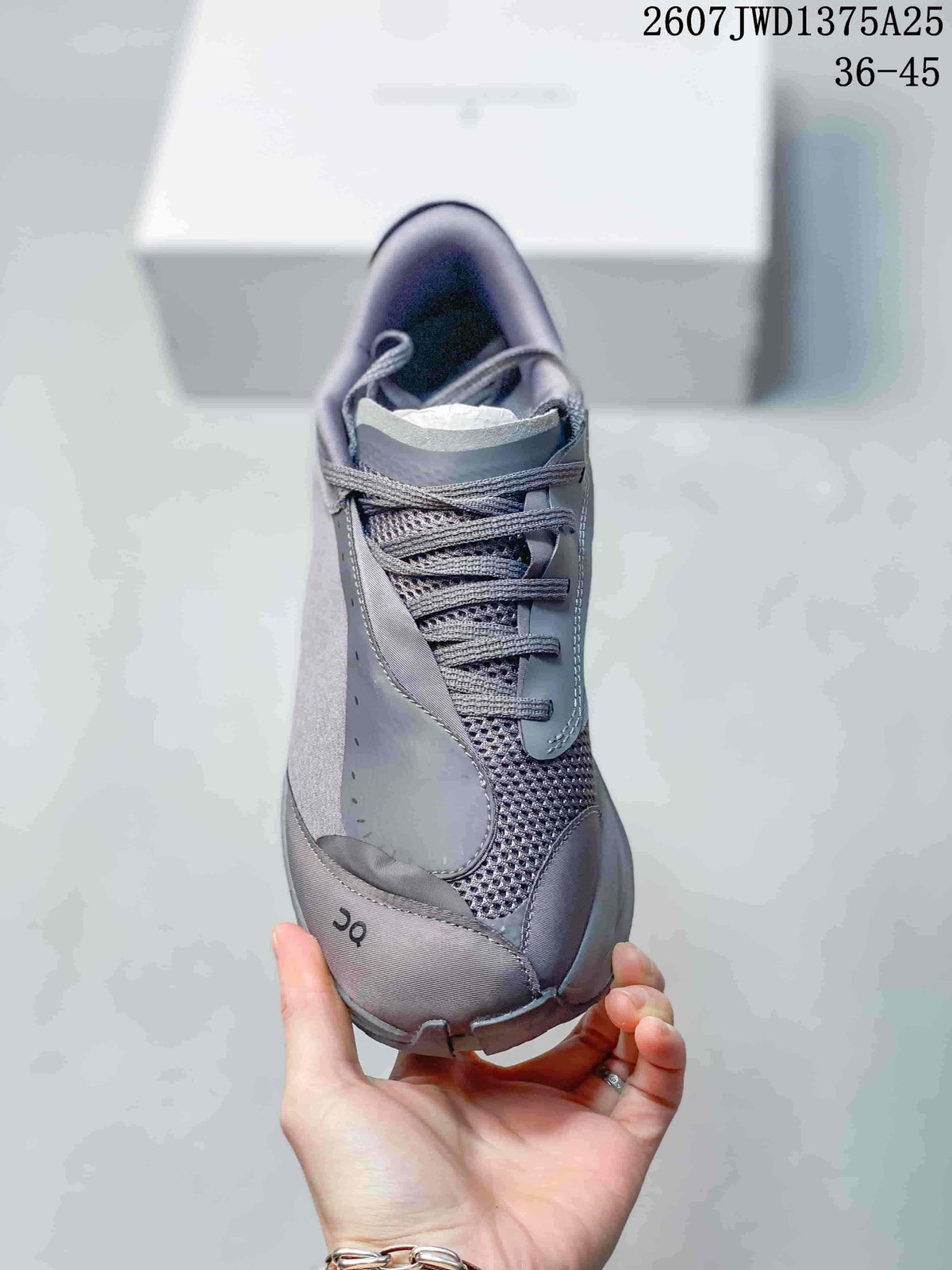 Top view of a gray lace-up sneaker showing the mesh tongue area, layered toe panels, and On logo detail.