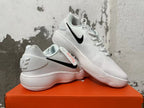 Pair of white Nike shoes with black Swooshes shown from the side