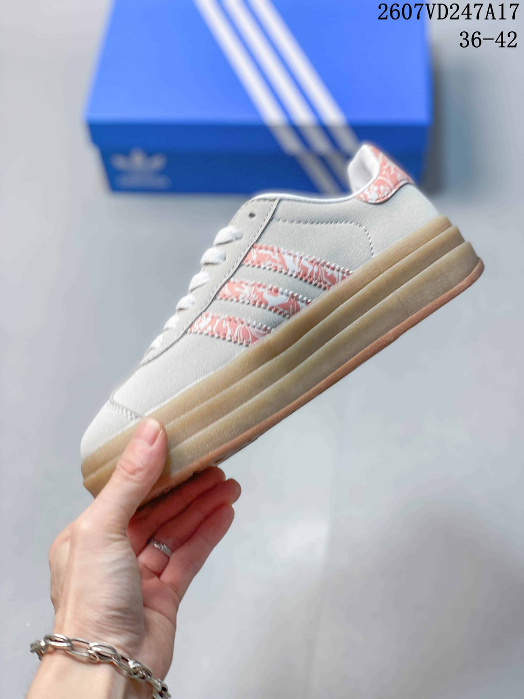 Side view highlighting the light-gray upper, pink patterned stripes, and platform sole.