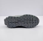 Underside view showing the segmented gray outsole with a lugged tread pattern and Alo branding.