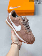 Side view of a light brown Nike Classic Cortez sneaker with white Swoosh, white midsole and gum-colored outsole.