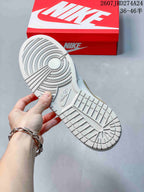 Underside view showing the circular-pattern rubber outsole of the sneaker.