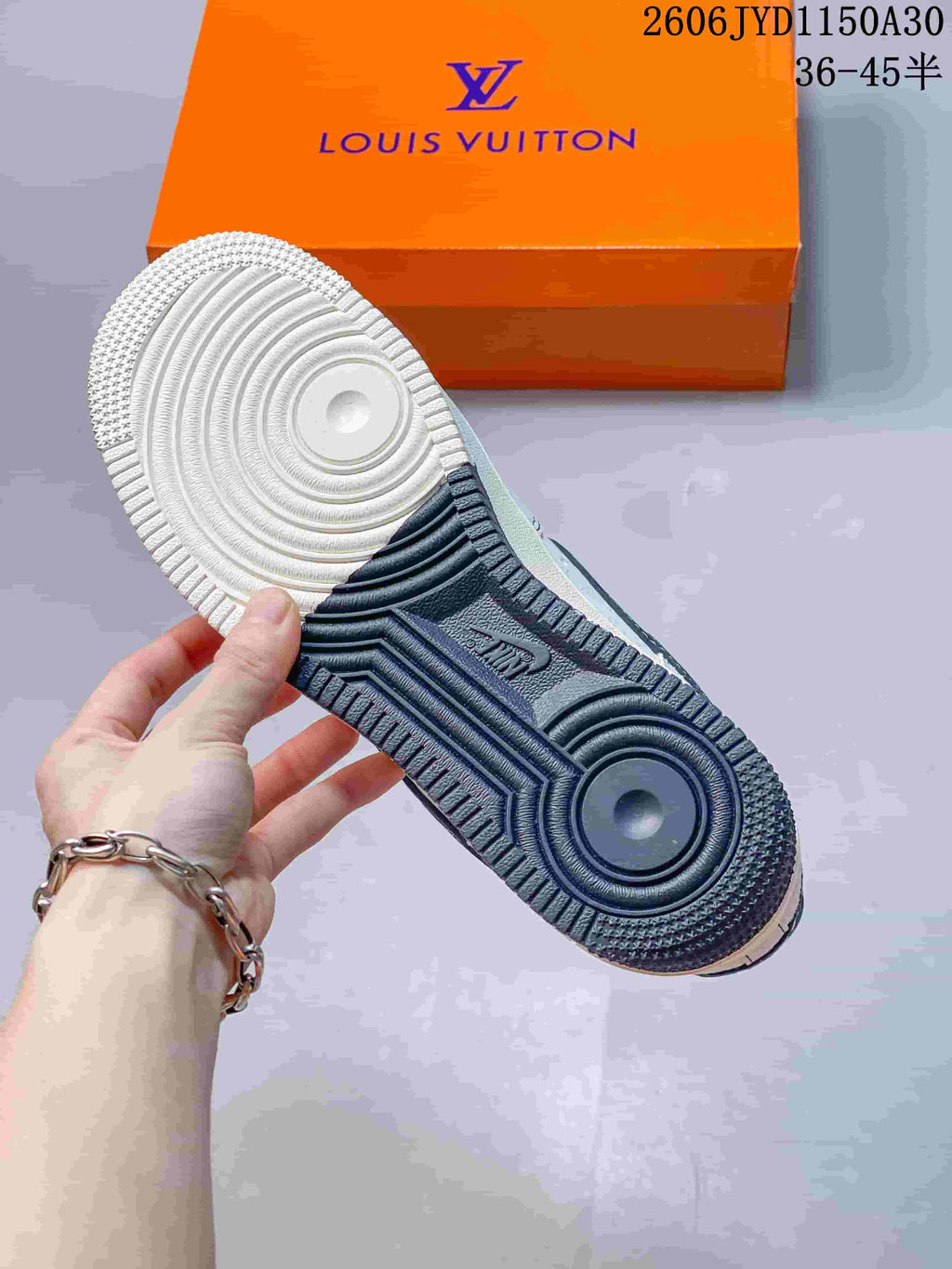 View of the sneaker outsole with contrasting light and dark sections