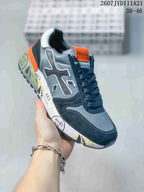 Angled side view of one grey, navy and orange Premiata sneaker with contrasting printed sole graphics.