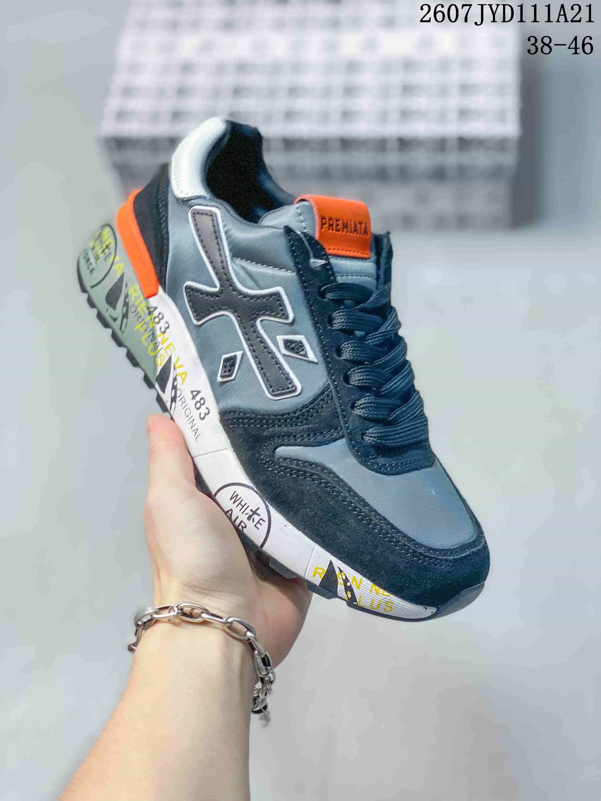 Angled side view of one grey, navy and orange Premiata sneaker with contrasting printed sole graphics.
