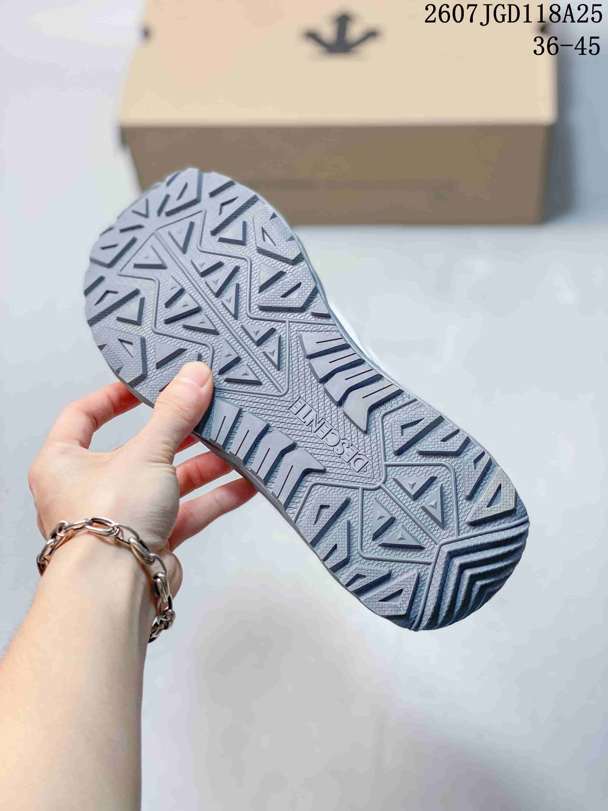Close-up of the patterned gray lugged outsole on a Descente hiking sneaker