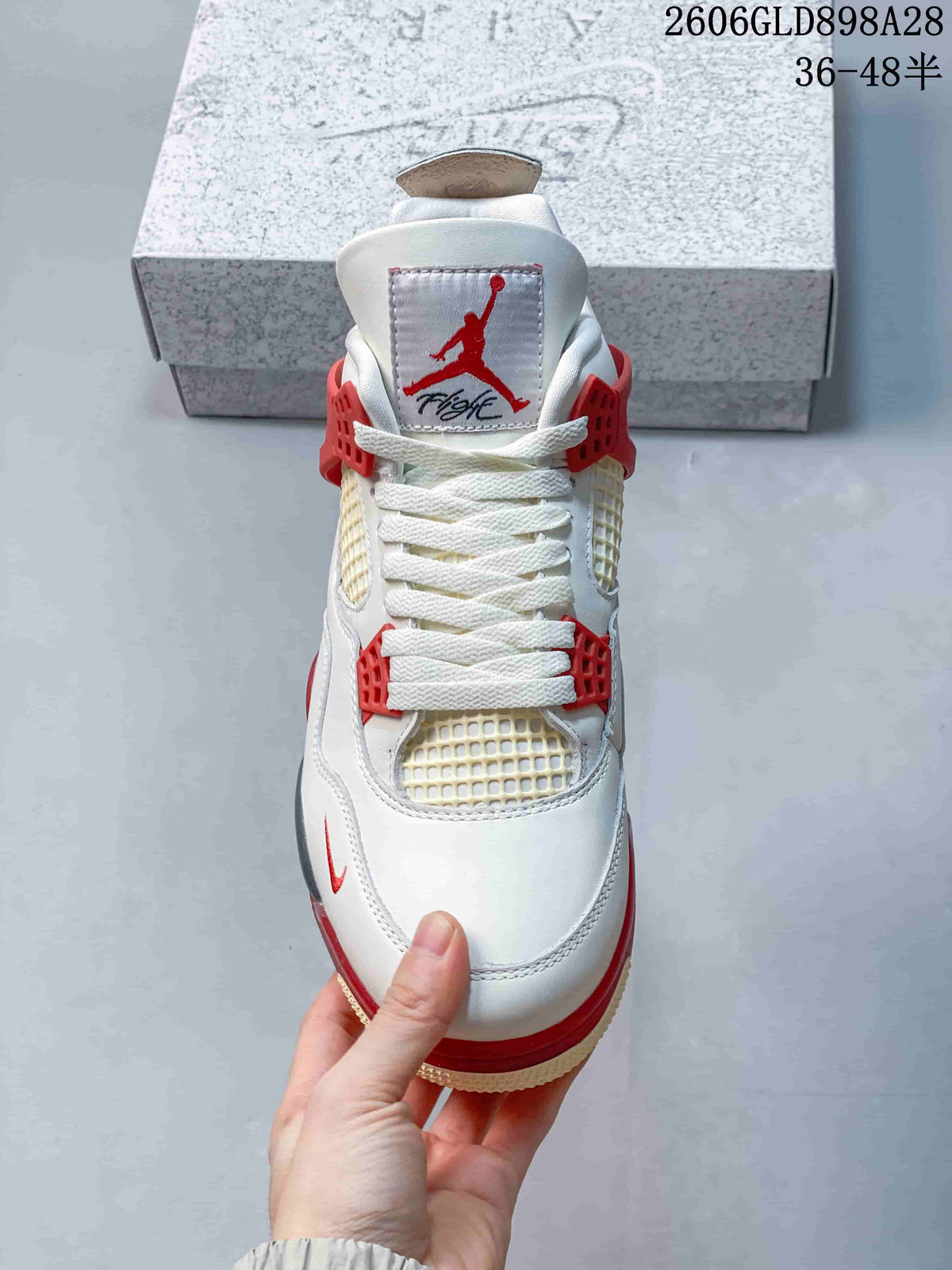 Front view showing the laces, mesh panels, and red accents.
