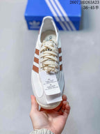 Top view showing the cream laces, brown side stripes and adidas branding on the tongue.
