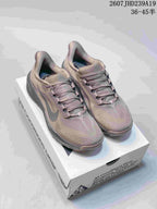 Pair of mauve-gray Nike ACG Pegasus Trail sneakers displayed on a shoebox.