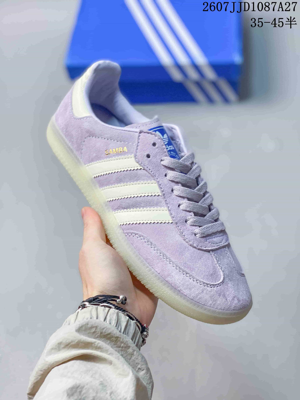 Angled side view showing the lavender upper, cream stripes, SAMBA detailing, and gum-colored outsole.