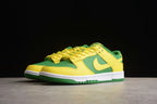 Pair of green and yellow sneakers shown from a low front three-quarter angle.