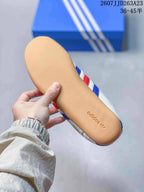 Underside view showing the gum-colored outsole with adidas branding.