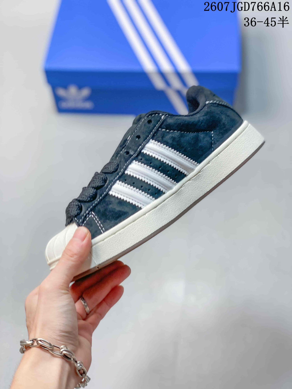 Side view showing the black upper, white three-stripe detailing, shell toe, and white midsole.
