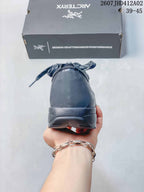 Rear view of the dark gray shoe with its heel and outsole visible