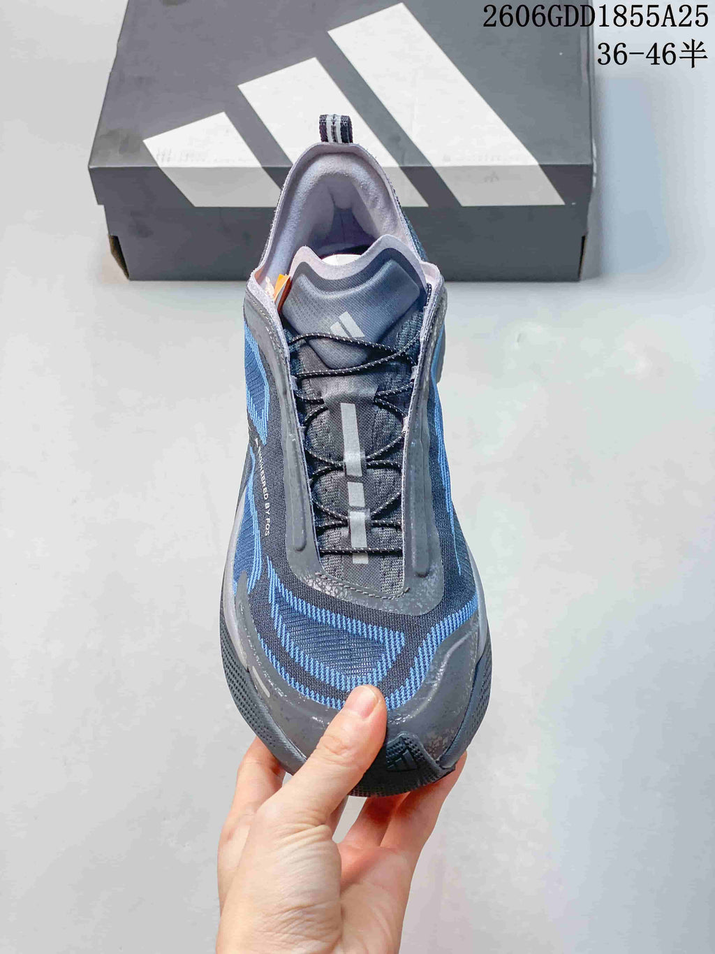 Front view of the gray and blue trail running shoe with lace-up closure