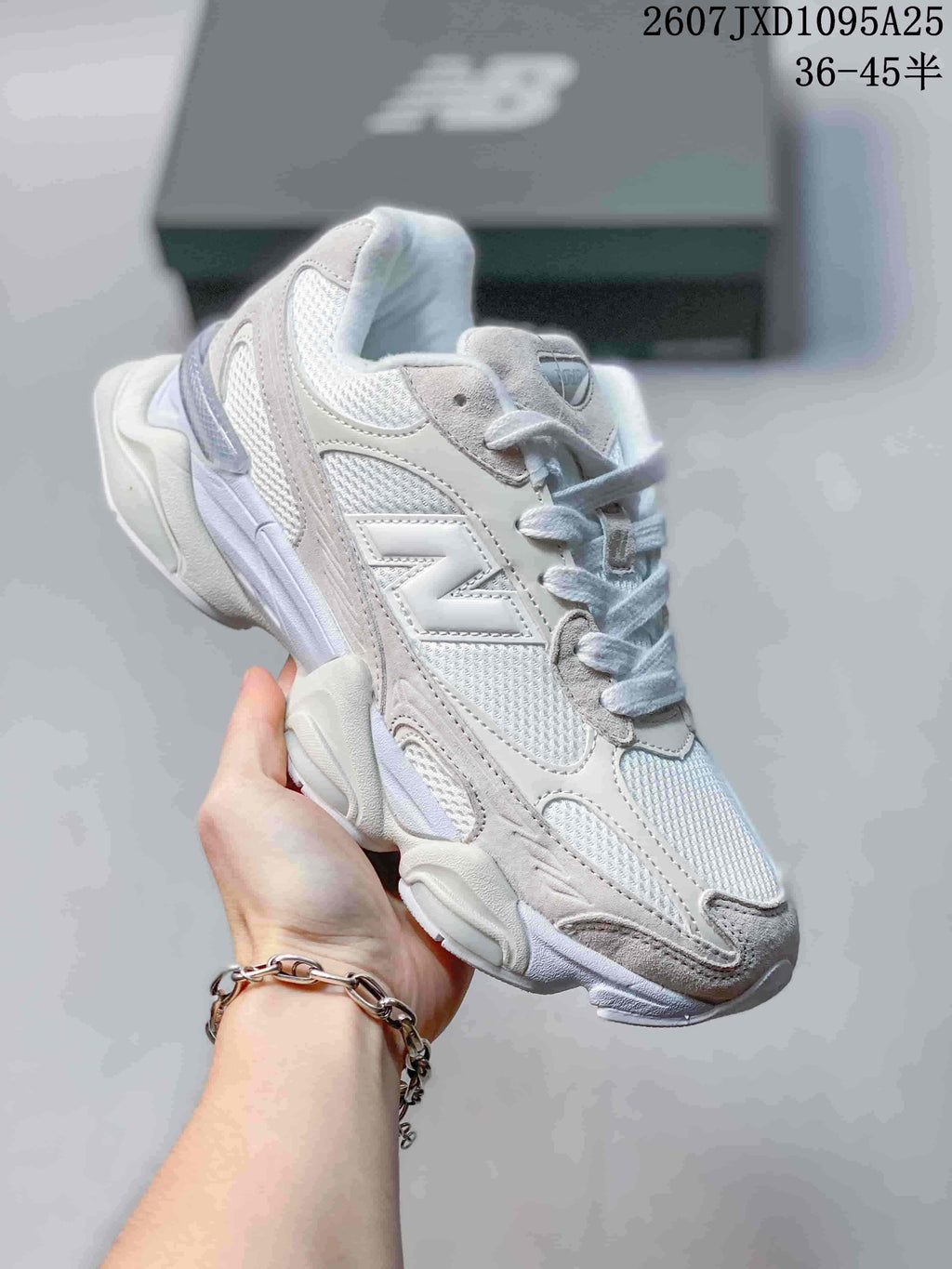 Angled side view of one light-colored New Balance 9060R sneaker with a large side logo.