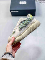 Side profile showing multicolor patterned panels and a ribbed beige sole