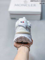 Rear view of the white sneaker showing the padded heel, red-and-blue detail and thick lugged outsole.