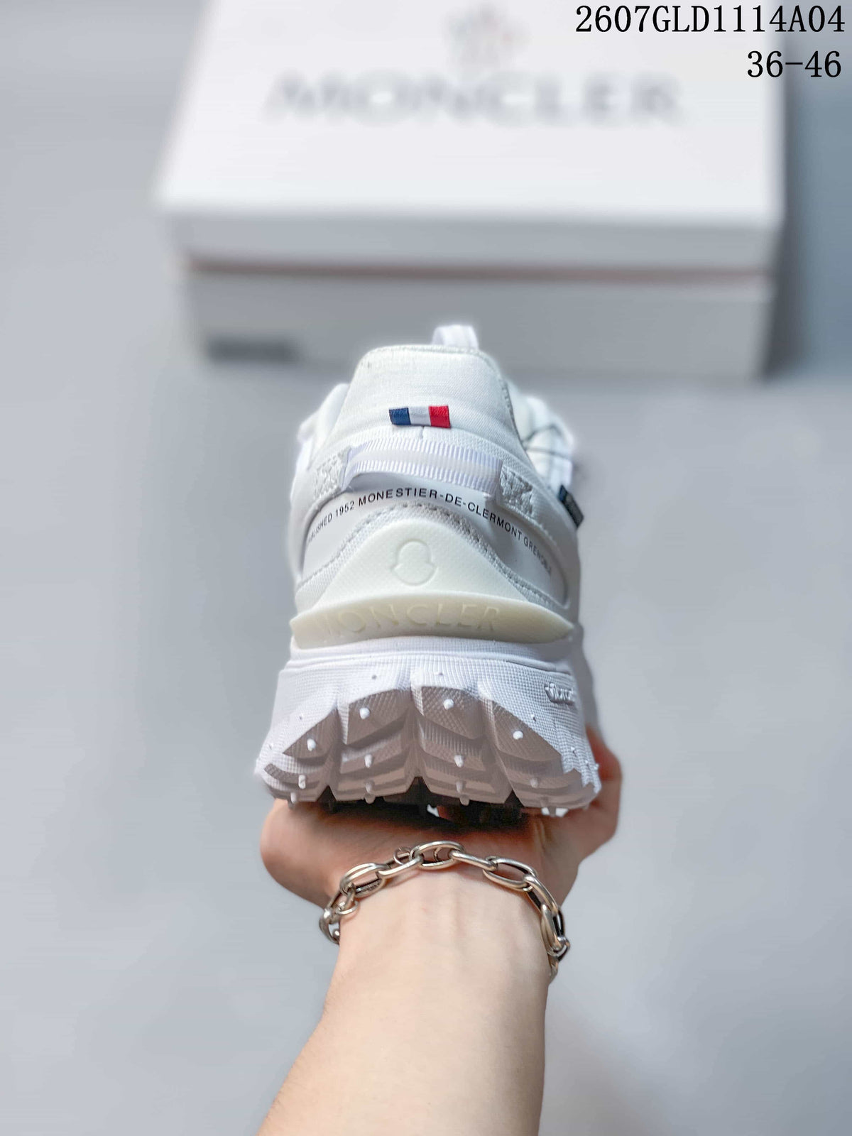 Rear view of the white sneaker showing the padded heel, red-and-blue detail and thick lugged outsole.