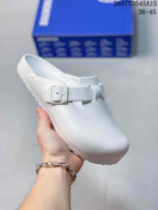 White closed-toe buckle sandal shown from above, highlighting the textured upper and adjustable strap.