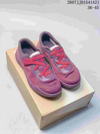 Pair of purple and red On Cloudnova sneakers displayed on a shoebox, with style code and size range visible above.