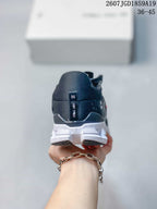 Rear view of the black sneaker showing the heel branding detail and white segmented outsole.