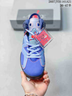 Front view of the blue high-top sneaker showing light-blue laces, red accents, perforated panels, and a branded hangtag.