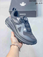 Side and top view of a dark DESCENTE sneaker showing the BOA dial, layered panels, and textured outsole.