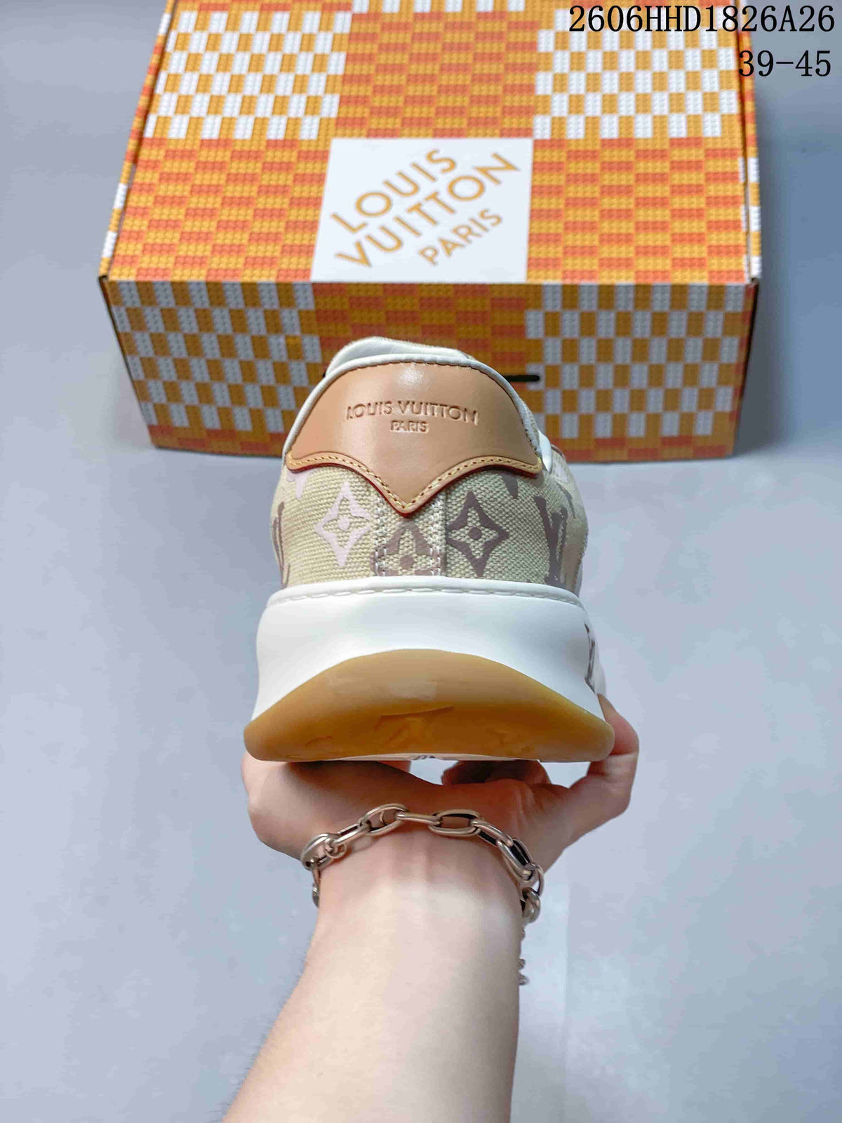 Rear view of a beige patterned sneaker with a tan heel tab, white midsole, and gum-colored outsole.