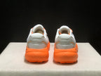 Rear view of the pair showing padded white heel sections and bright orange outsoles.