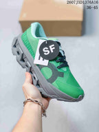 Angled side view of the green sneaker showing the green upper, black detailing, gray sole, and attached hangtag.