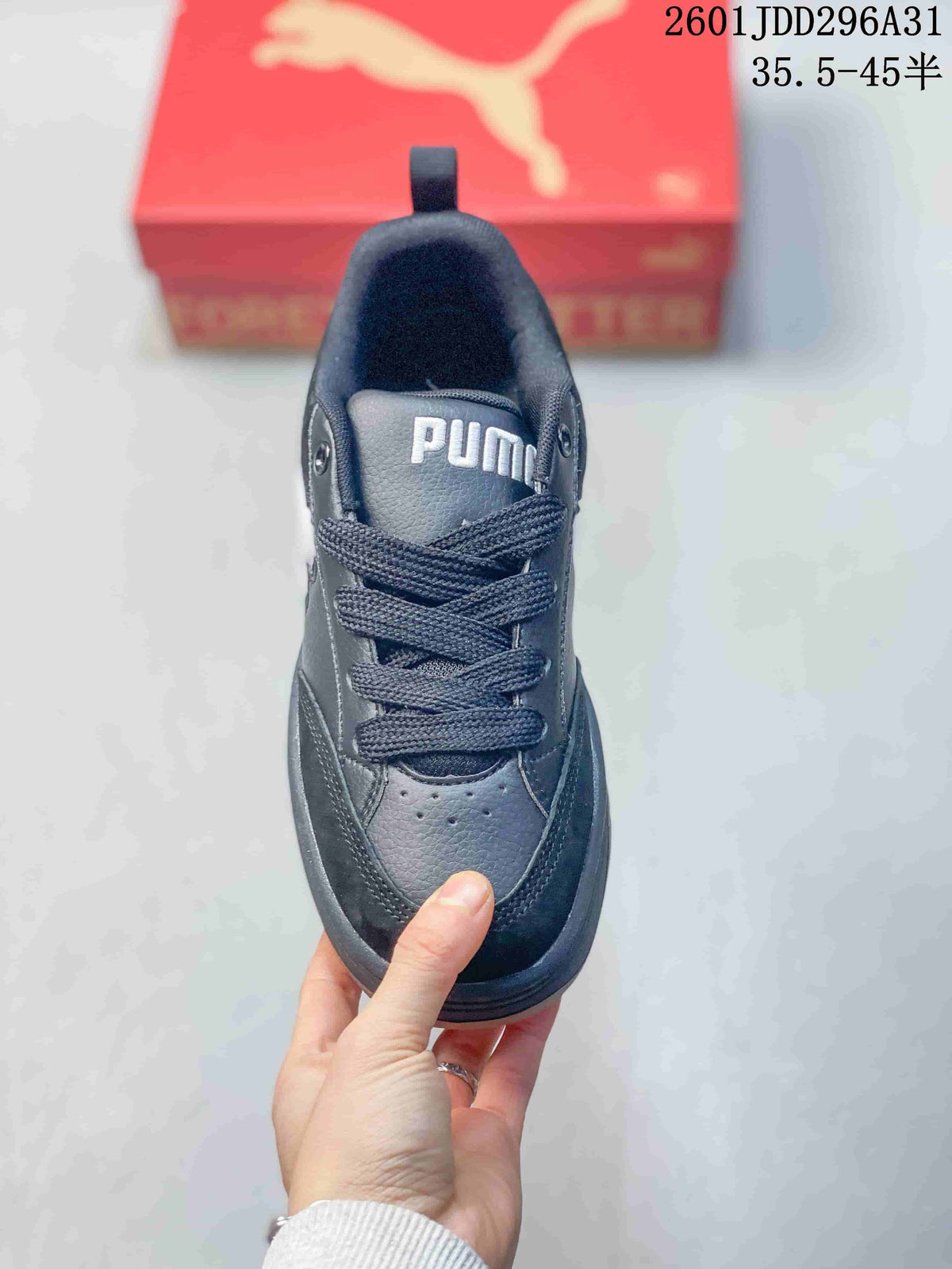 Top view of a black PUMA lace-up sneaker showing the tongue branding, eyelets and perforated toe area.