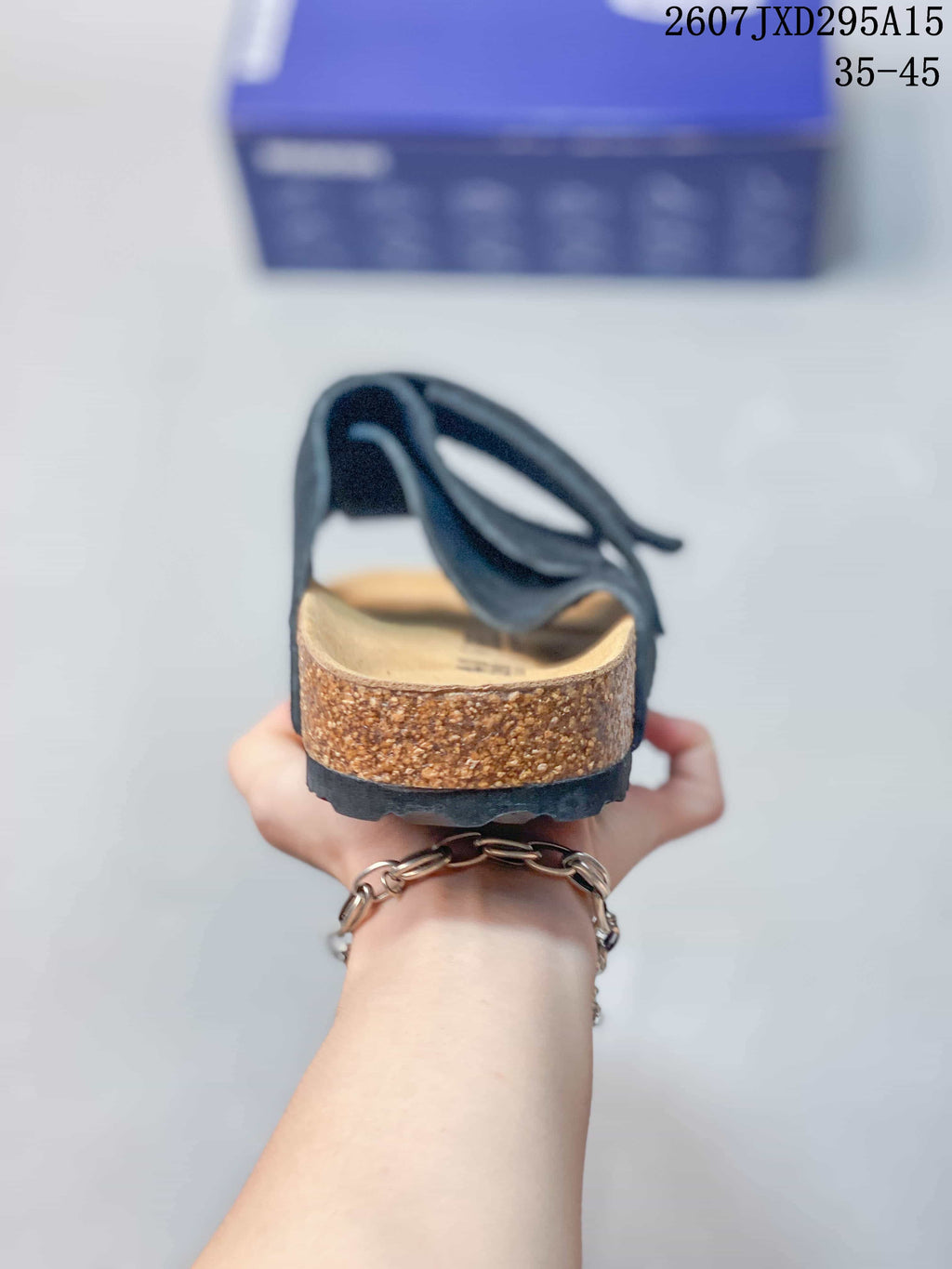 Rear view showing the open heel, cork-look footbed sidewall and black outsole.
