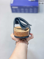 Rear view showing the open heel, cork-look footbed sidewall and black outsole.