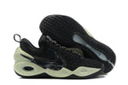 Black Nike Anthony basketball shoes with pale green soles and dark side details.