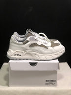 Side view of white and grey sneakers showing layered panels, textured inserts and Off-White side branding.