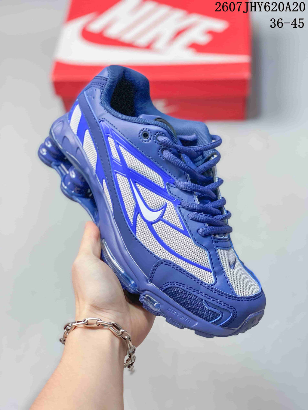 Angled side view of the blue and white sneaker showing layered overlays, Nike branding and the segmented blue sole.