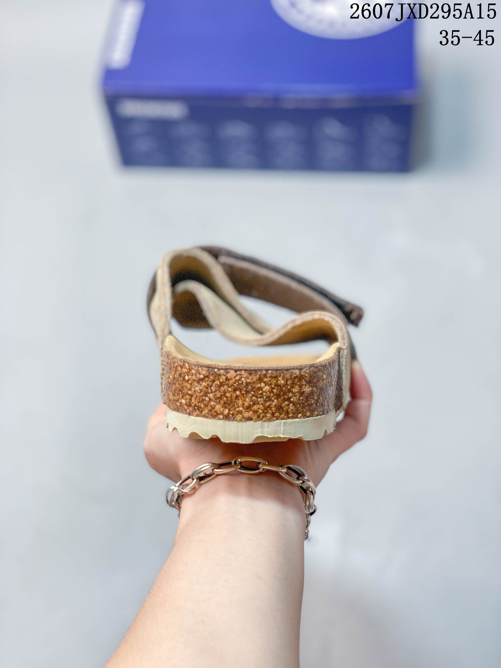 Rear view showing the open heel, cork-look midsole and textured outsole.