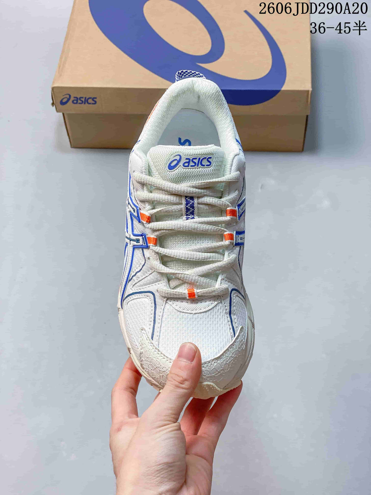 Top view of the sneaker showing the lace-up construction, mesh-like upper, and ASICS tongue branding.
