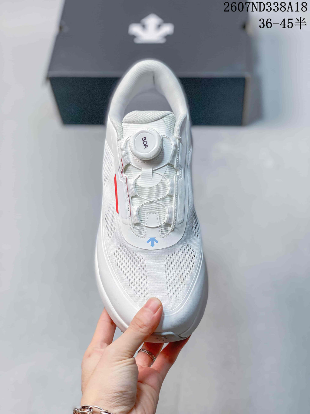 Top view of the white sneaker showing the BOA dial, structured tongue and perforated forefoot.